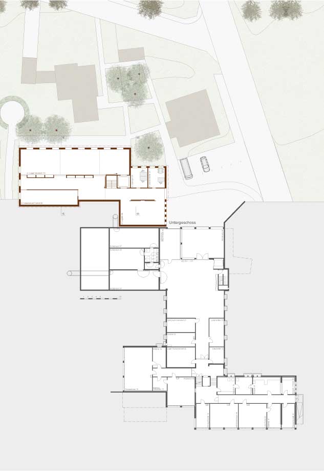 **Erweiterung Stiftung Egnach, Egnach TG, Untergeschoss** Der Neubau fügt sich zwischen die bestehende Werkstatt und zwei Wohnhäuser der Stiftung ein. Er übernimmt die Volumetrie und die Dachform des Bestandes und führt die Anlage kammartig fort.  Zusammen mit dem Werkstattgebäude und dem Wohnhaus bildet der Neubau zur Bucherstrasse einen räumlich gefassten Zugangsbereich, welcher für die Anlieferung und Parkierung genutzt wird. Der kleine Hof zwischen Alt- und Neubau dient als Pausen- und Aufenthaltsraum. Ein einfaches Wegnetz verbindet das Werkstattgebäude mit den Wohnhäusern. Eine neue Baumgruppe gliedert den Freiraum und spendet kühlenden Schatten. Der bestehende Rundweg wird um den Neubau herum verlängert. Vor dem Untergeschoss des Neubaus ist ein befestigter Platz vorgesehen, welcher für Arbeiten im Freien genutzt werden kann.  Der neue Arbeitsraum im Erdgeschoss ist barrierefrei an den Bestand angebunden. Die Garderoben sind dem Arbeitsraum vorgelagert. Der Korridor weist eine zum Manövrieren mit Paletten ausreichende Breite auf. Im Untergeschoss unmittelbar beim Eingang ist die Logistik zentral zwischen Eingang und Aufzug und je ein Büro für den Bereichsleiter und den Springer angeordnet. Das Warenlager und der Materialraum sind in wenigen Schritten vom Aufzug aus zu erreichen. Beide Räume verfügen über eine gute Tageslichtsituation und sind so konzipiert, dass sie auch als Arbeitsort genutzt werden können.  Der neue Arbeitsraum ist für eine optimale Nutzungsflexibilität stützenfrei überspannt und reicht bis unter den First. Die Decke über dem Untergeschoss ist zur Reduktion ihrer Aufbauhöhe in der Gebäudemitte auf einer Traglinie aufgelagert und zur Aufnahme der geforderten Nutzlasten in Beton gehalten.  Die Statik - Fundamente, Wände und Decke - ist so dimensioniert, dass eine nachträgliche Aufstockung ohne Verstärkungen aufgenommen werden kann. Das Satteldach würde für die Aufstockung abgebaut und ein Geschoss höher, über einer neuen Zwischendecke, wieder aufgebaut werden. Das Gebäude wäre damit für ein weiteres Geschoss bereit.